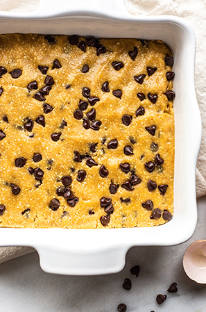 unbaked cookie bars in a white dish