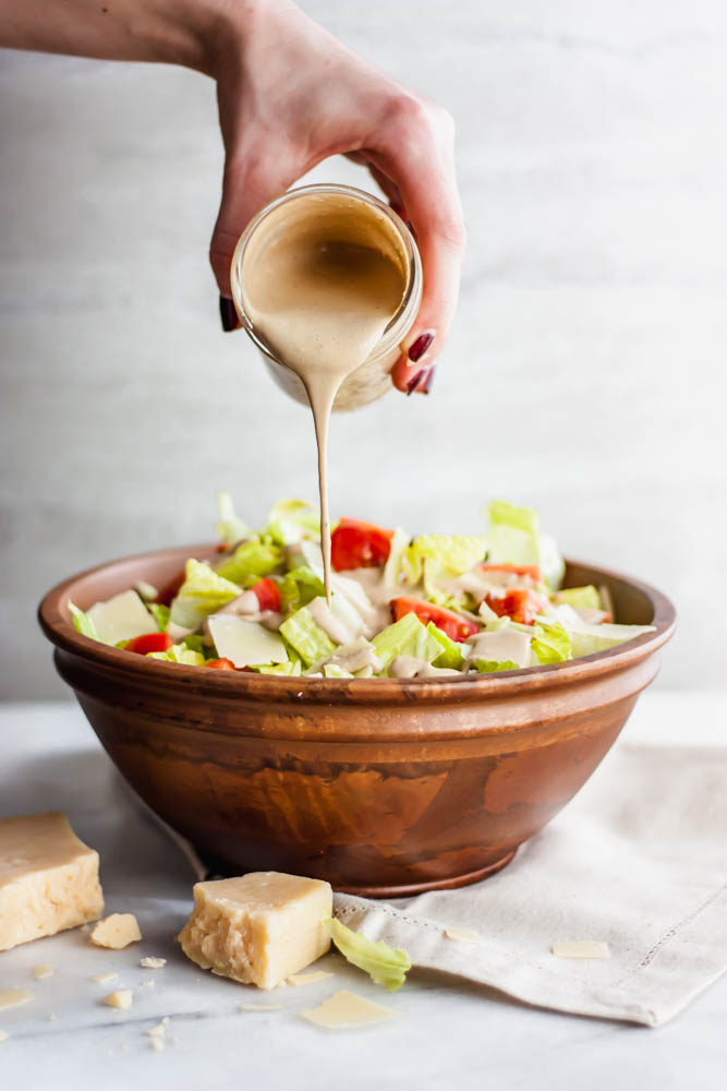 Pouring dressing onto a salad