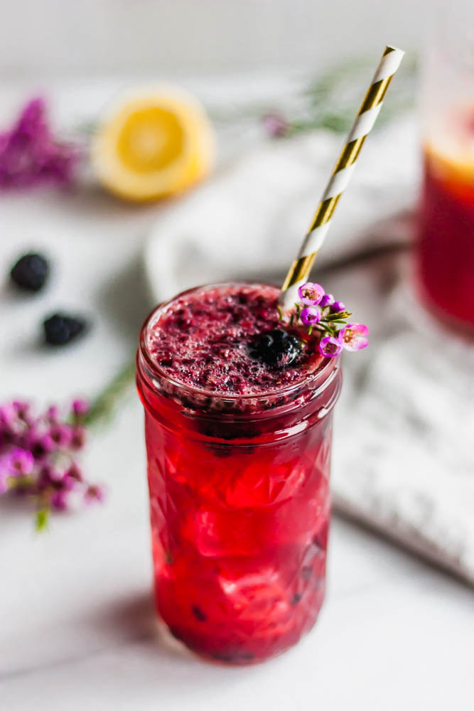 A delicious vodka lemonade infused with fresh blackberry and honey and topped with bubbly hibiscus kombucha. The perfect summer drink.