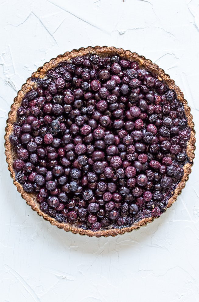 paleo blueberry tart on a white background