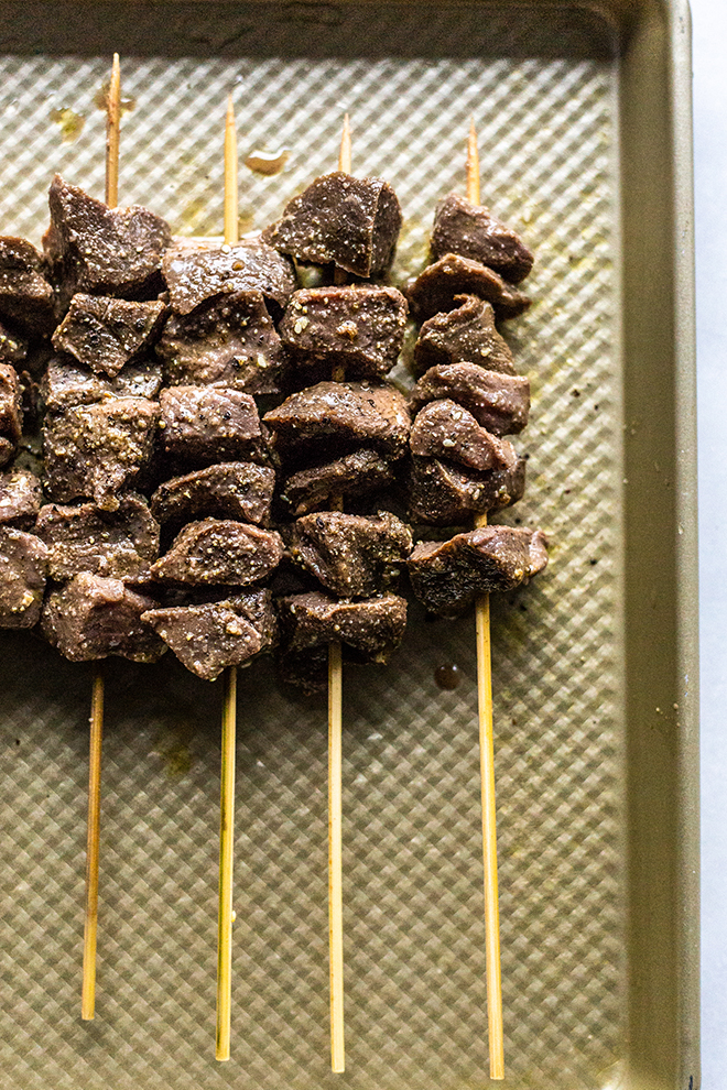 venison skewers marinated on a sheet pan 