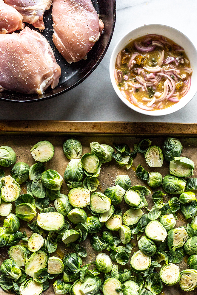 ingredients for chicken thighs and Brussels sprouts in a skillet and a sheet pan 