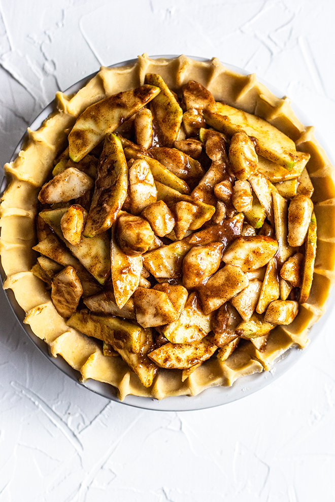 unbaked apple pear pie on a white background 