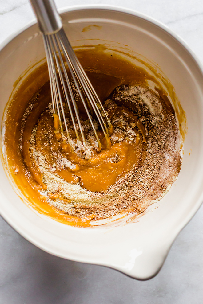 paleo pumpkin bread batter in a cream bowl on a marble background 