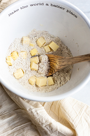 butter in a white bowl with flour and a spoon