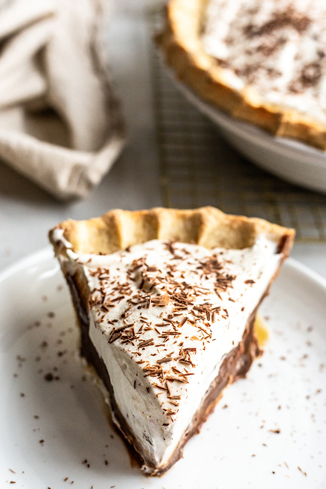 chocolate pie with whipped cream on top on a white plate