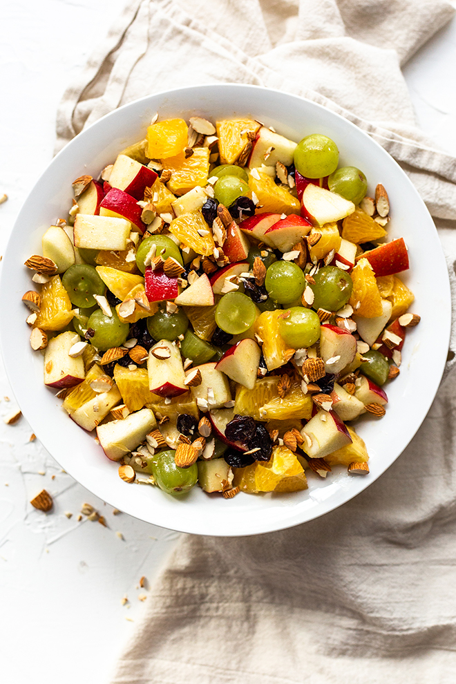 This Winter Fruit Salad combines fruit slices, chopped almonds, and cinnamon infused vinaigrette for an easy, no bake or cook side dish for the cold months and Holidays.