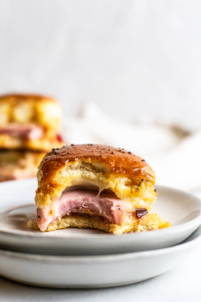 ham slider with cheese on white plates on a white background 