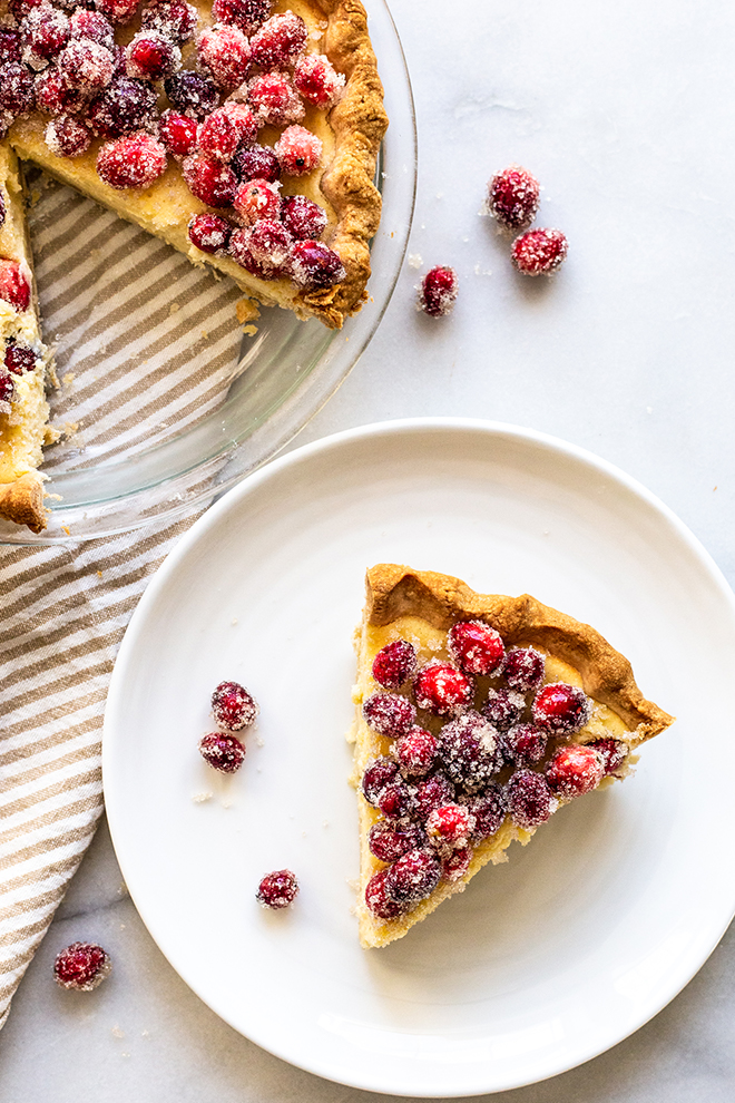 Delicious Buttermilk Cheesecake Pie bakes up like a rich cheesecake in pie crust with Sugared Cranberries to top it off with tartness and festivity.