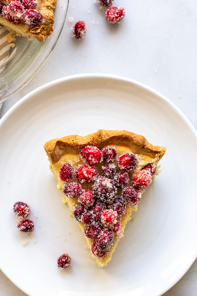 pie slice with cranberries on a white plate