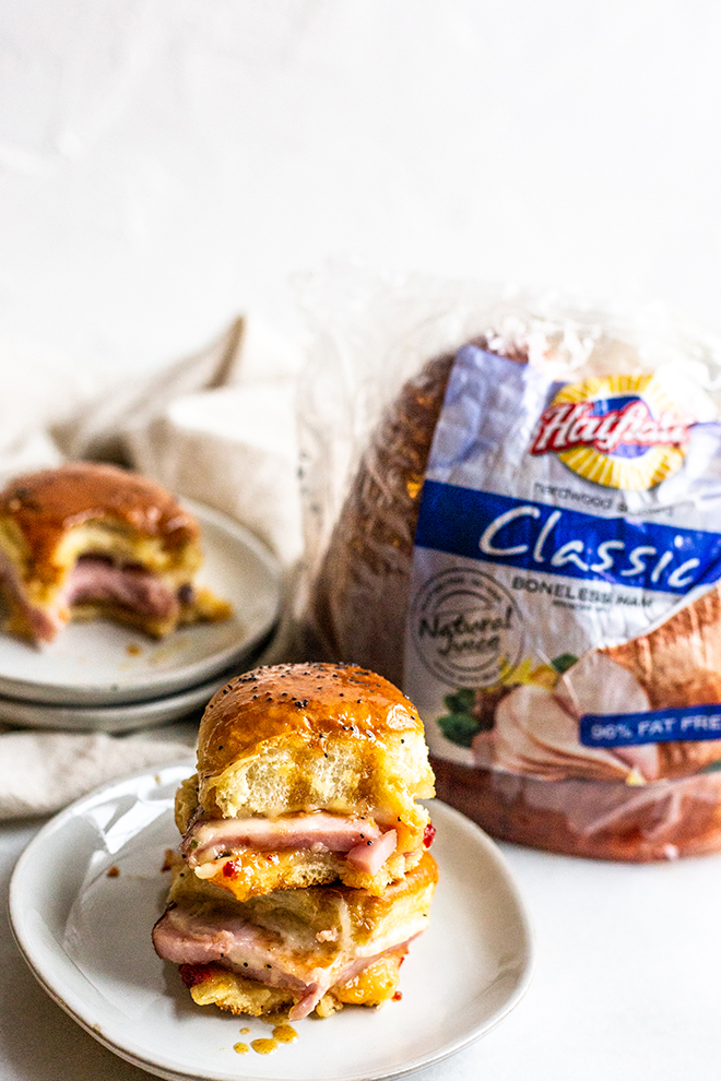 Red Peppery Jelly Ham Sliders are filled with thick slices of ham, spicy pepper jelly, and gooey Havarti cheese. They're the perfect Holiday lunch and you can use up some leftover ham!