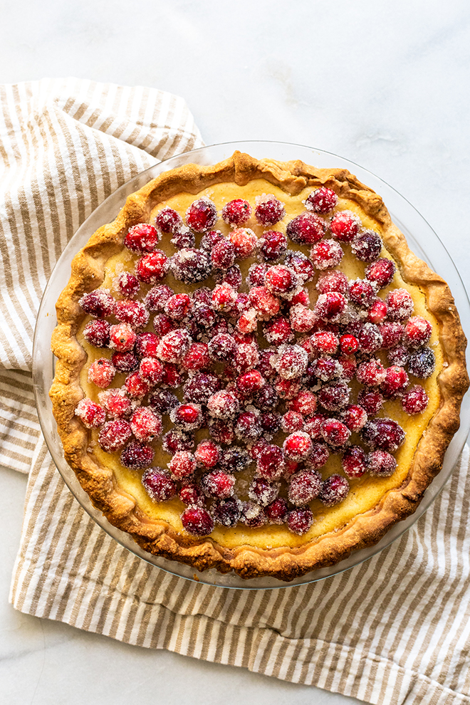 Delicious Buttermilk Cheesecake Pie bakes up like a rich cheesecake in pie crust with Sugared Cranberries to top it off with tartness and festivity.