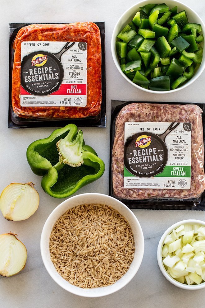 all of the ingredients for stuffed pepper soup on white marble 