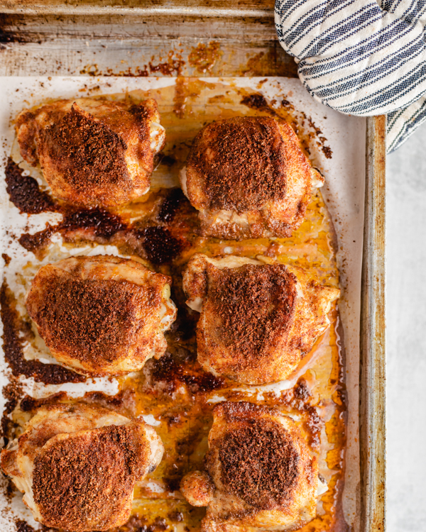 bone-in roasted chicken thighs on a baking sheet