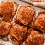 bone in skin on chicken thighs on a baking sheet, unbaked