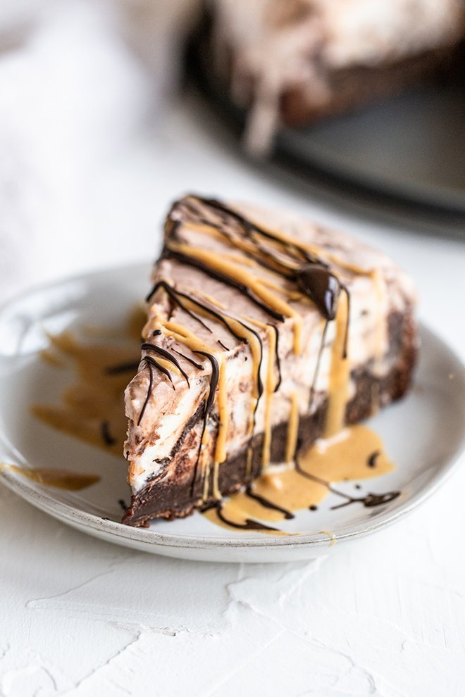 A thick brownie crust is shaped in a springform pan and is filled with decadent peanut butter cup ice cream. An ice cream cake pie mashup!