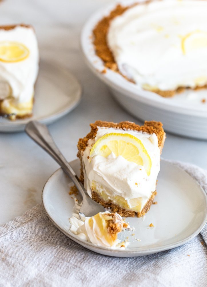 Crunchy and buttery graham cracker crust is filled with tart lemon filling and topped with fresh, lemon cream. A perfect, refreshing dessert. 