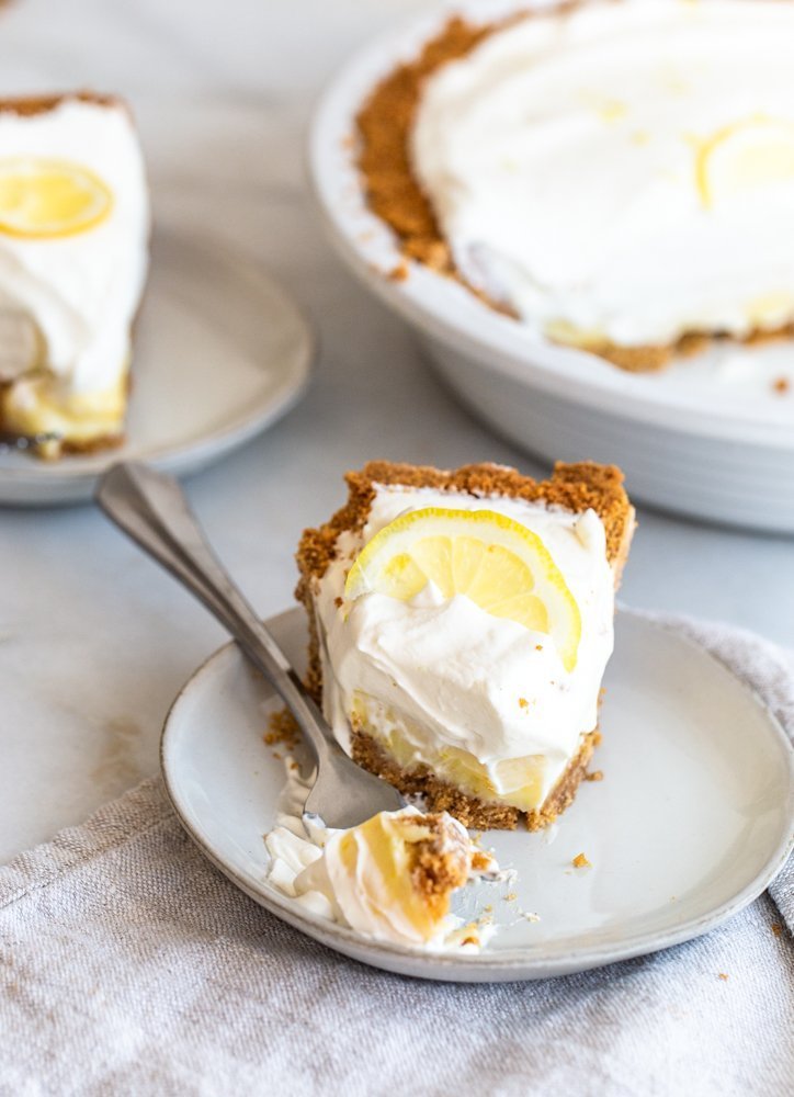 Crunchy and buttery graham cracker crust is filled with tart lemon filling and topped with fresh, lemon cream. A perfect, refreshing dessert.