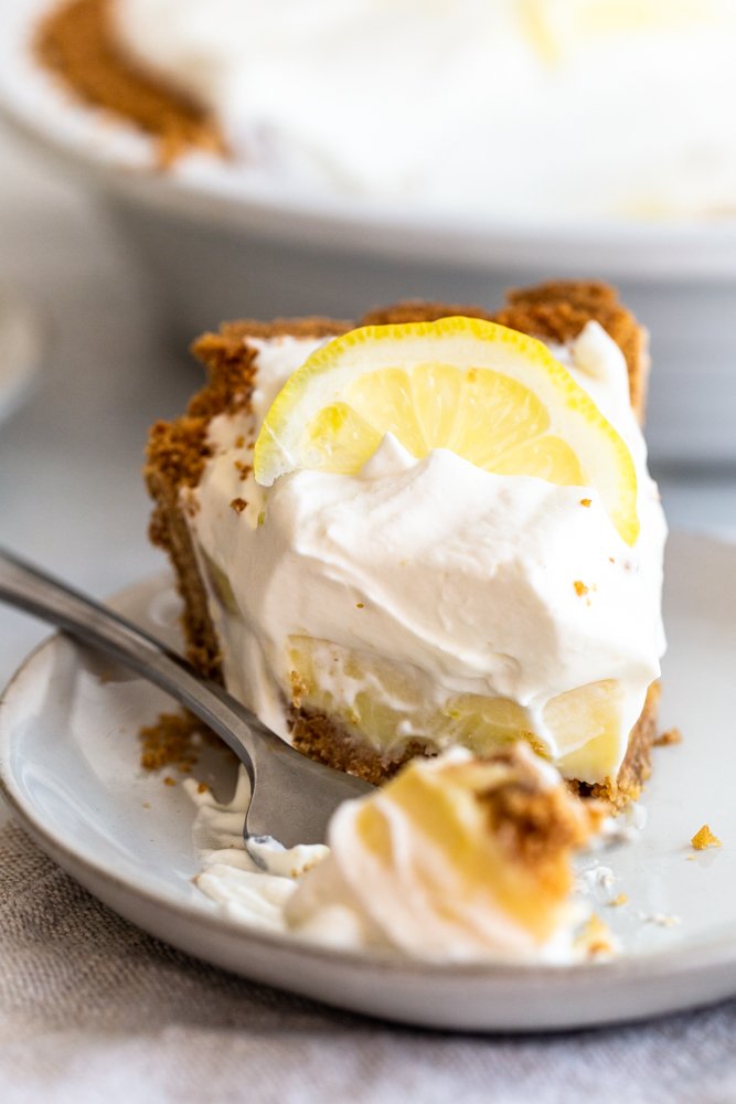 Crunchy and buttery graham cracker crust is filled with tart lemon filling and topped with fresh, lemon cream. A perfect, refreshing dessert.