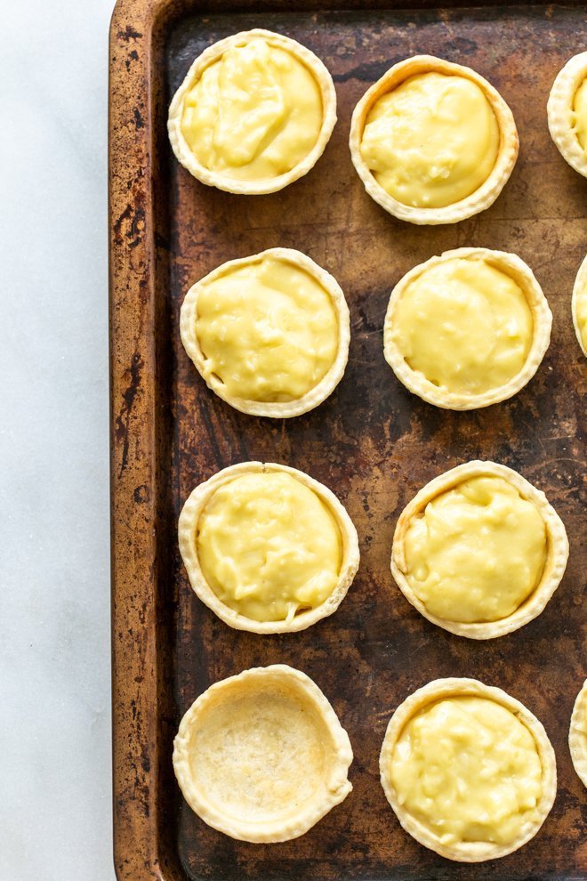 mini coconut cream pies on a baking sheet