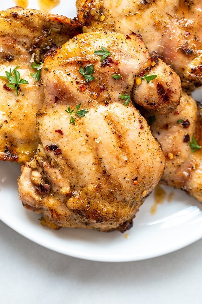 honey honey grilled chicken thighs stacked with parsley