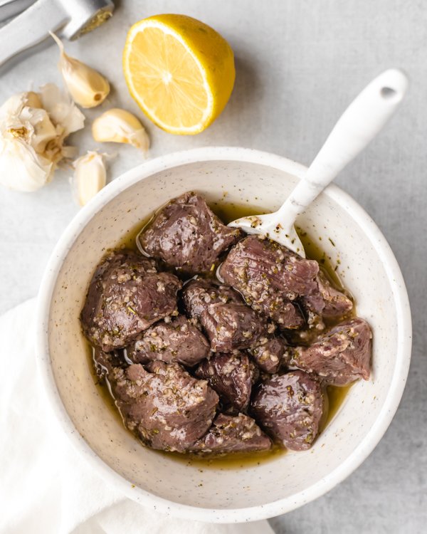 venison marinade over cubed venison in a bowl