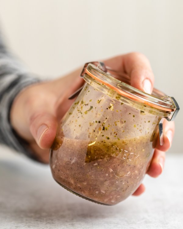 venison marinade in a glass jar being shook