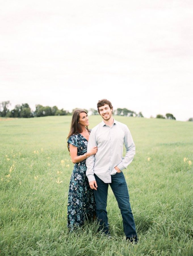 husband and wife in a green field