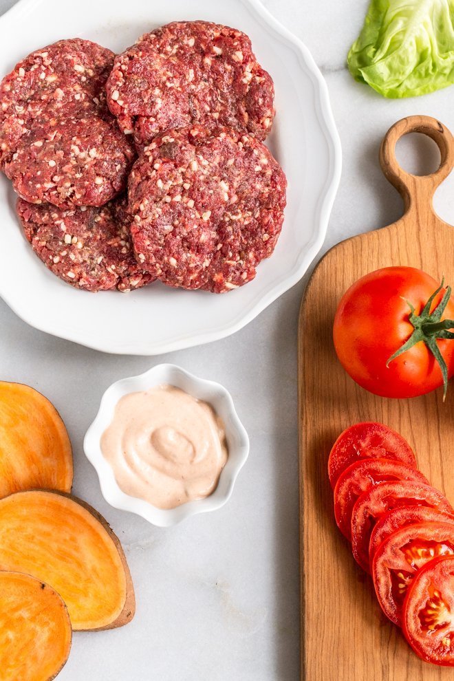 all of the ingredients Venison Burgers on a white background