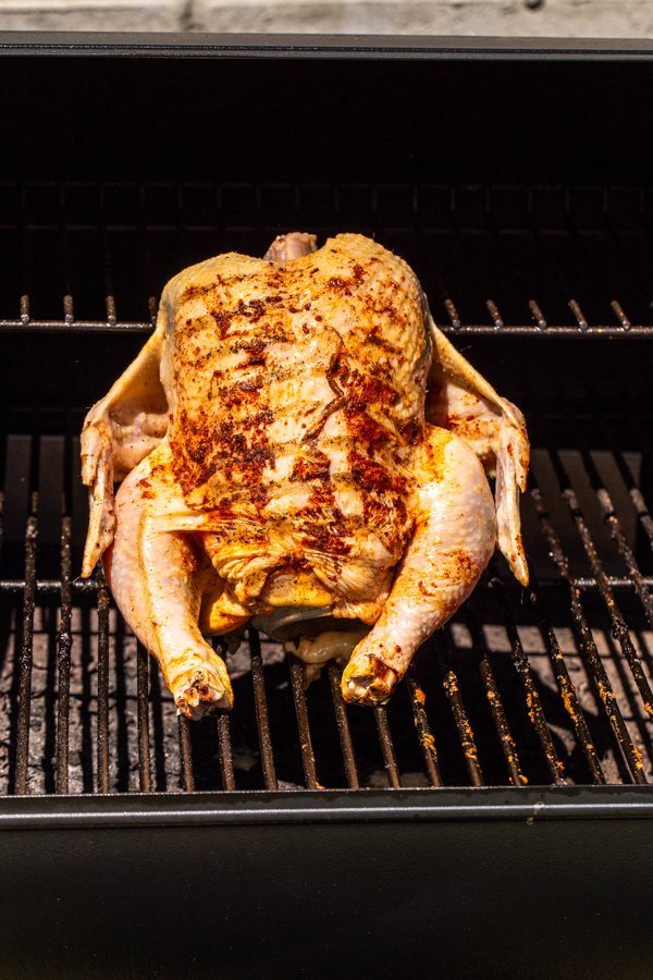 beer can chicken sitting on a wood pellet Traeger grill