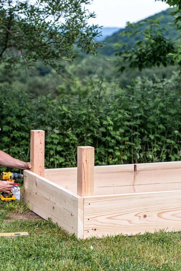 a raised wood garden bed overlooking the mountains