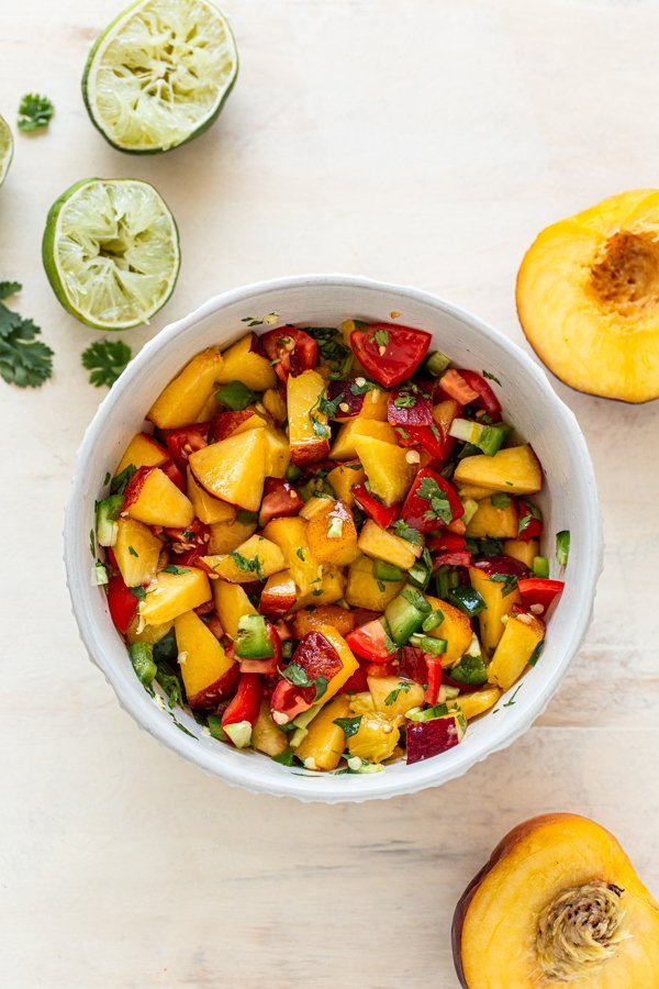 fresh peach salsa in a white bowl