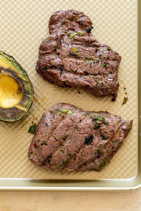 grilled elk steaks fresh off the grill on a baking sheet