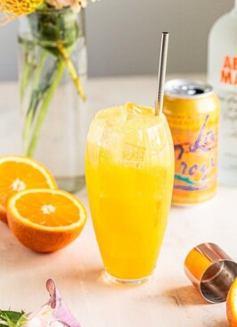 an orange crush in a clear tall glass