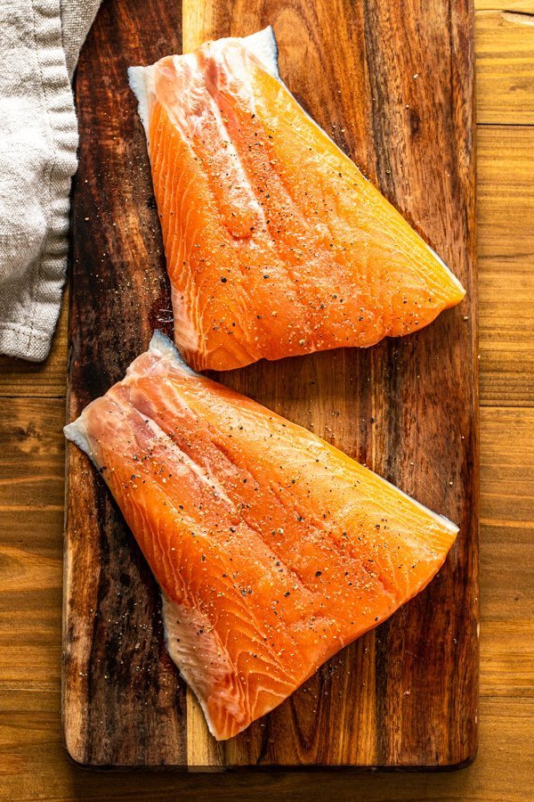 salmon fillets on a wooden board