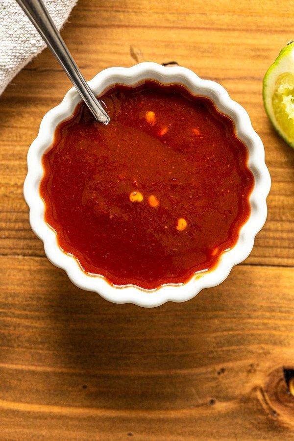 sweet and spicy sauce in white ramekin with a spoon