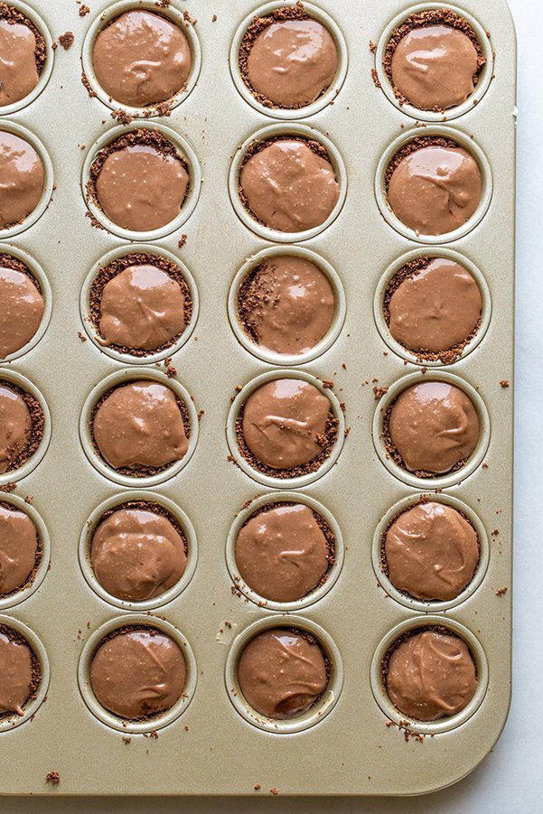 chocolate cheesecake bites in a mini muffin tin