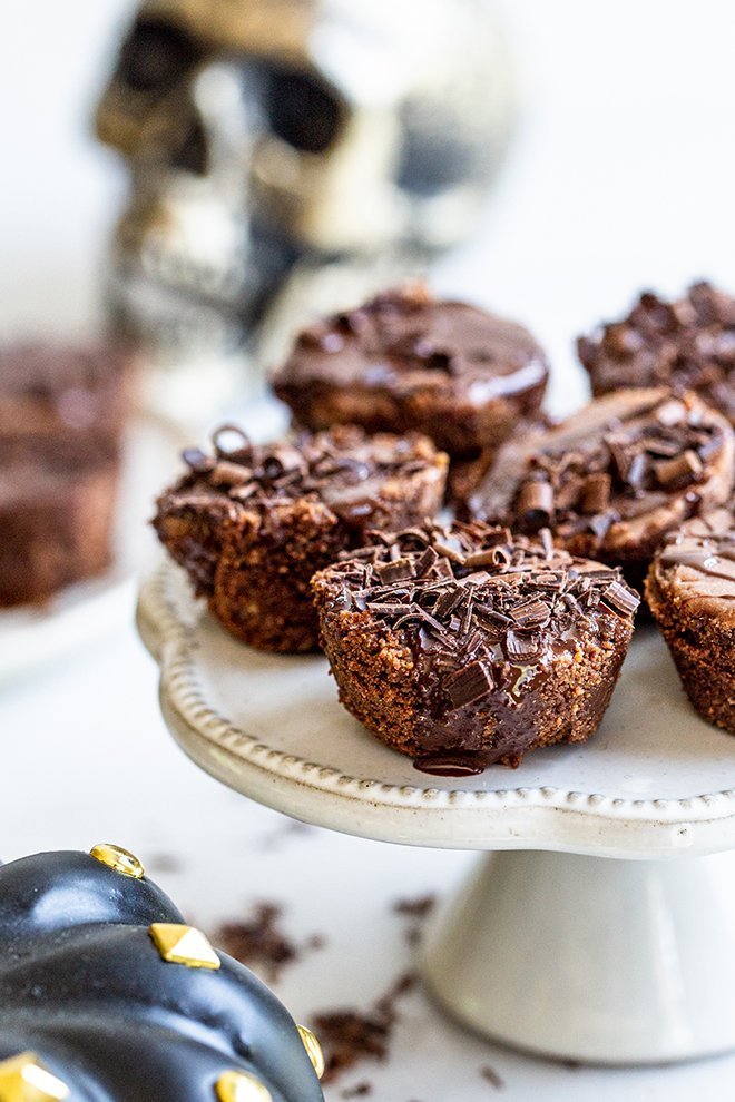 chocolate cheesecake bites on a stand with shaved chocolate