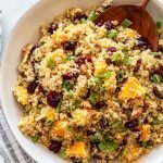 orange cranberry quinoa salad in a white bowl