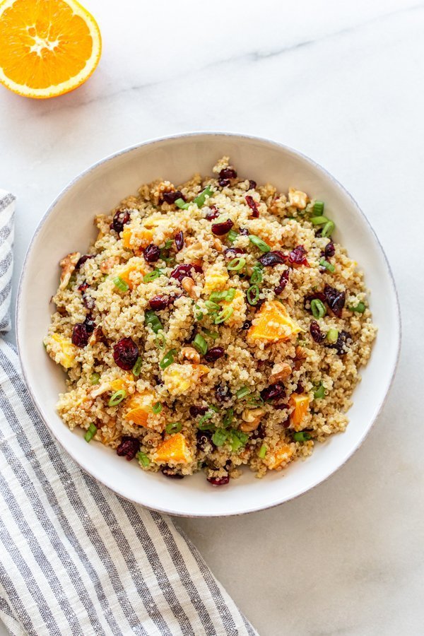 orange cranberry quinoa salad in a white bowl