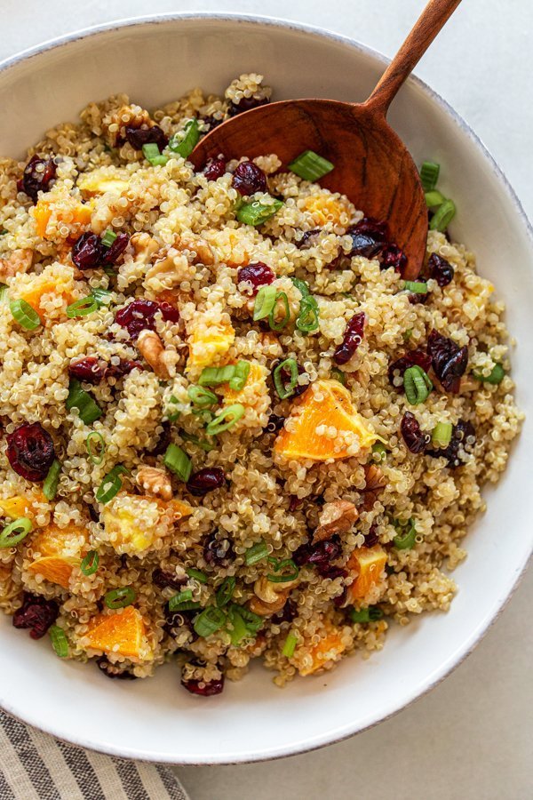 orange cranberry quinoa salad in a white bowl