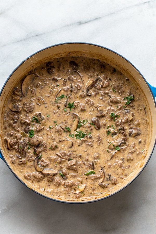 stroganoff sauce with venison and mushrooms in a dutch oven
