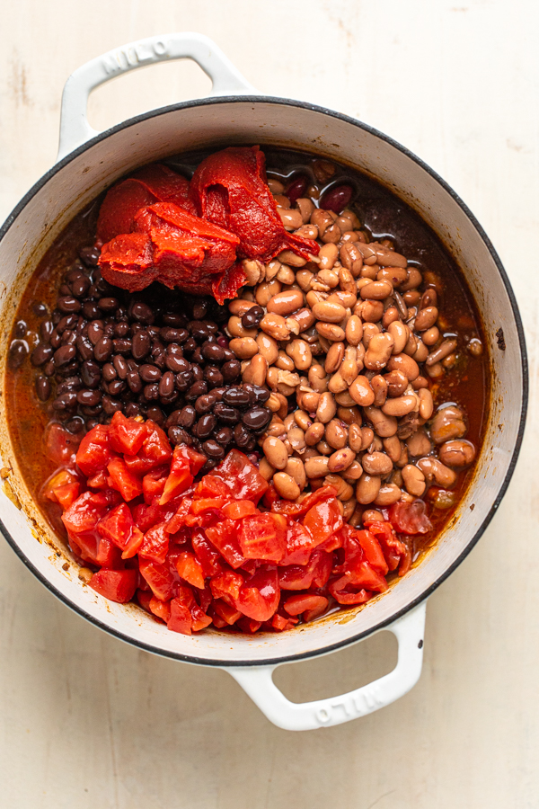 beans and tomatoes in a white pot