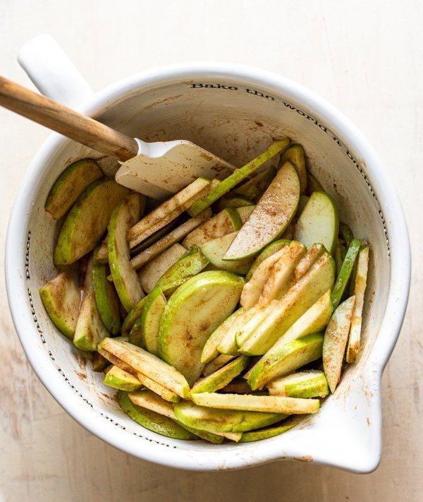 apples with spices in a white bowl