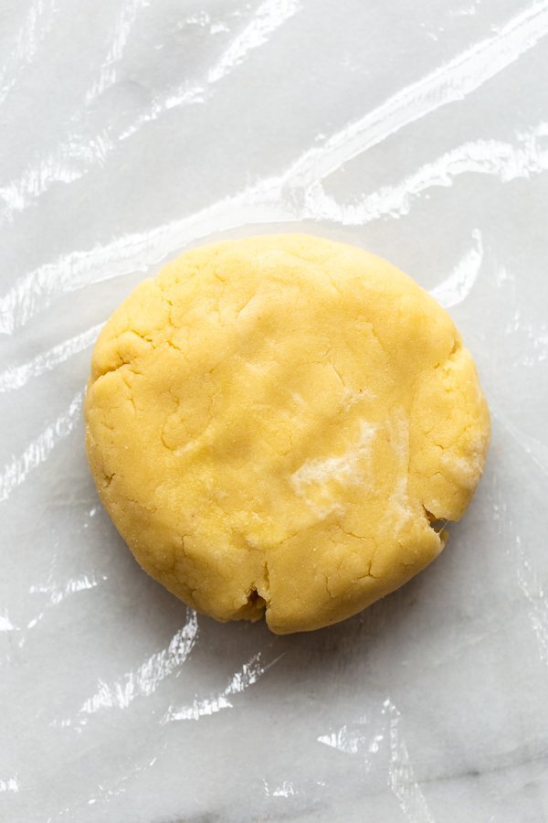 disc of gluten free pie dough on a piece of plastic