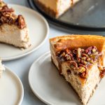 Pecan Pie Cheesecake slices on white plates