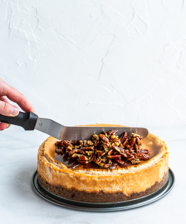 Pecan pie filling spread over cheesecake