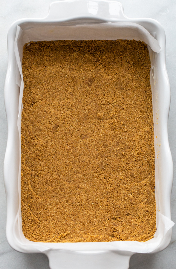 graham cracker crust in the bottom of a baking sheet