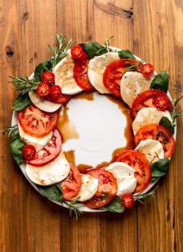 Caprese salad made into a wreath shape on a white plate