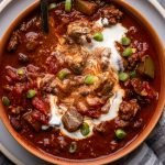 bear chili with a swirl of sour cream in a bowl